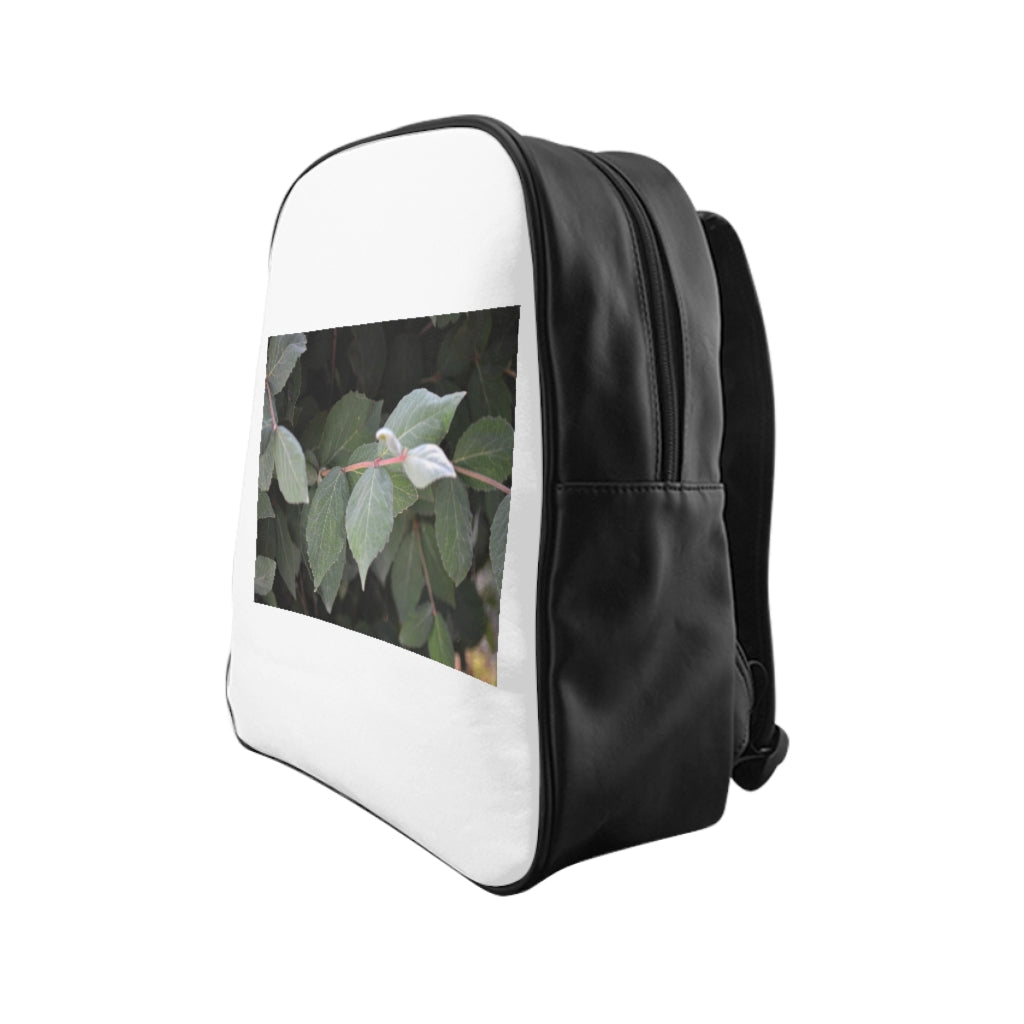 Green Leaves School Backpack featuring a vibrant green leaves print, padded back, and multiple inside pockets for organization.