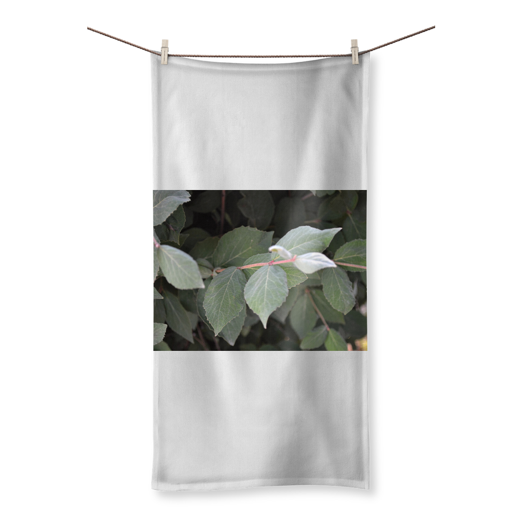 Green Leaves Sublimation All Over Towel featuring vibrant leaf designs on one side and soft cotton backing on the other.