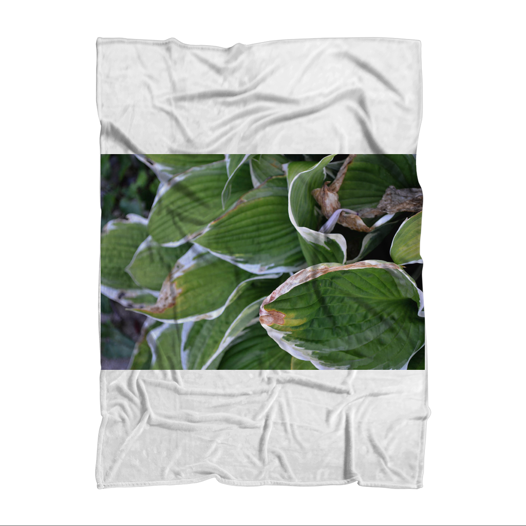 Green Leaves Sublimation Throw Blanket made of soft polar fleece, featuring a vibrant leaf design on one side and a white back.