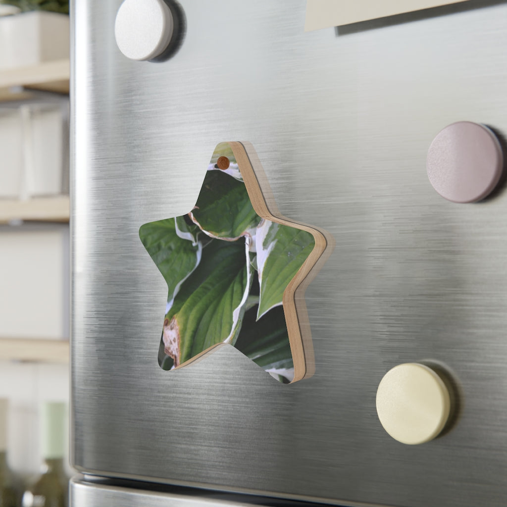 A collection of Green Leaves Wooden Christmas Ornaments in various whimsical shapes, featuring a rustic wooden finish and red hanging ribbons.