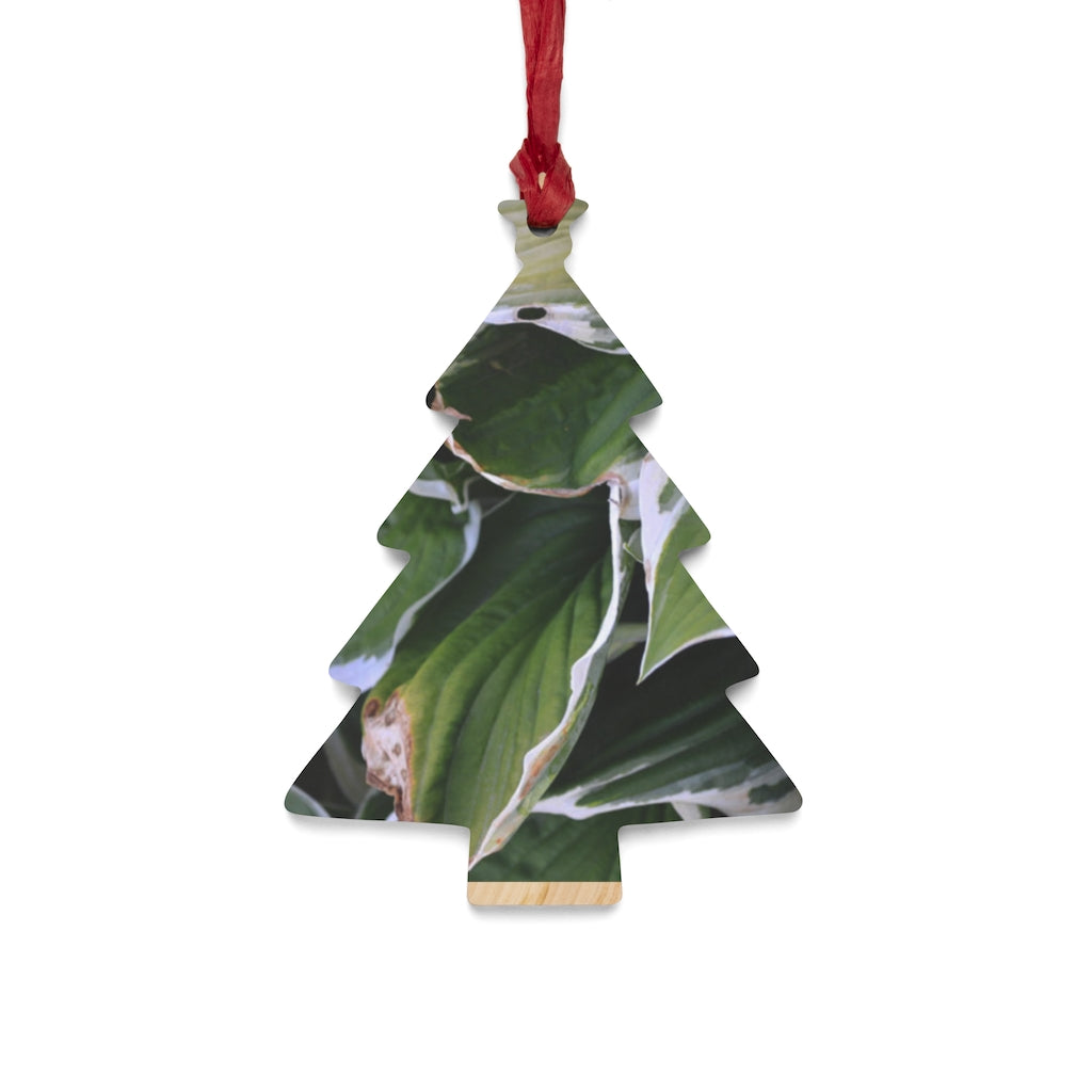 A collection of Green Leaves Wooden Christmas Ornaments in various whimsical shapes, featuring a rustic wooden finish and red hanging ribbons.