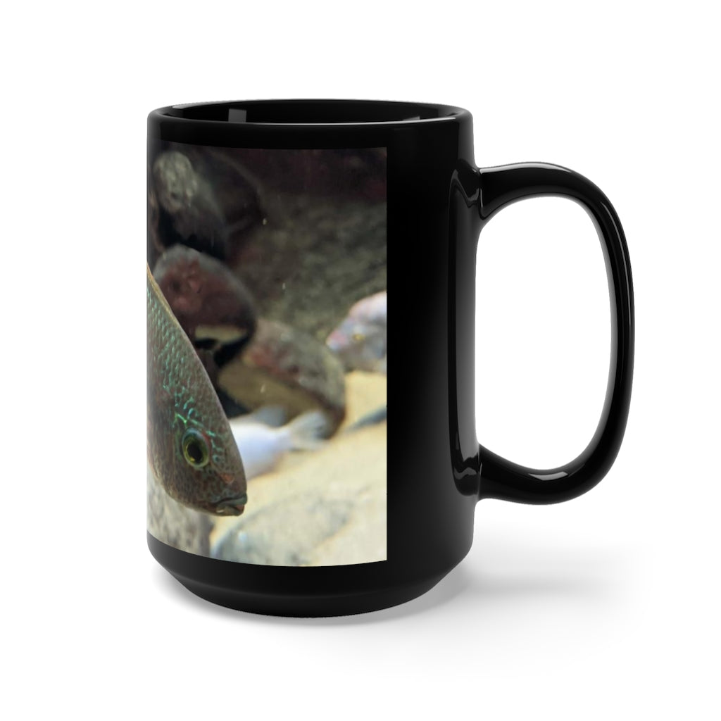 A stylish black ceramic mug featuring a grey and orange fish design, perfect for coffee and tea lovers, with a 15oz capacity.