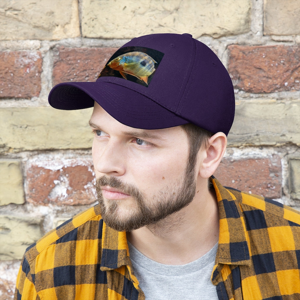 Grey and orange unisex twill hat with adjustable Velcro closure, perfect for outdoor activities and everyday wear.