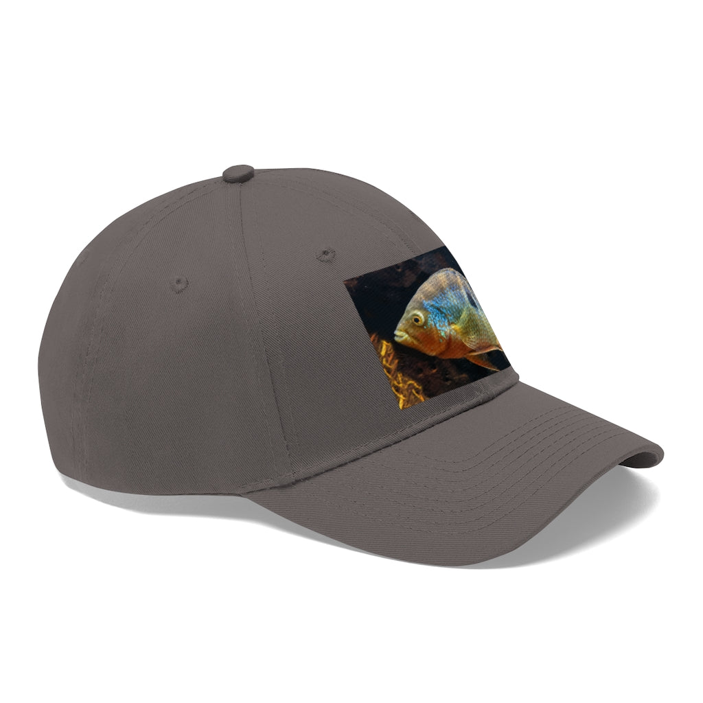 Grey and orange unisex twill hat with adjustable Velcro closure, perfect for outdoor activities and everyday wear.