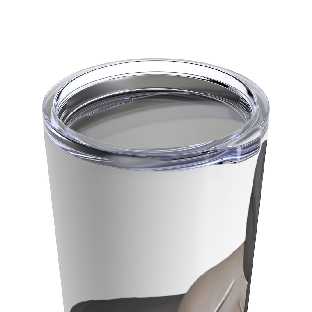 Grey Dog Tumbler 20oz made of stainless steel with a see-thru plastic lid, showcasing its sleek design and rounded corners.