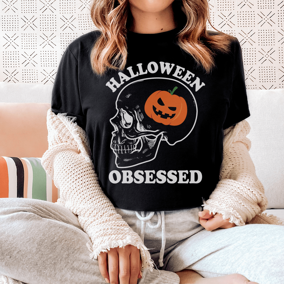 A black Halloween Obsessed T-Shirt featuring spooky graphics, made from soft ring-spun cotton with double stitching for durability.