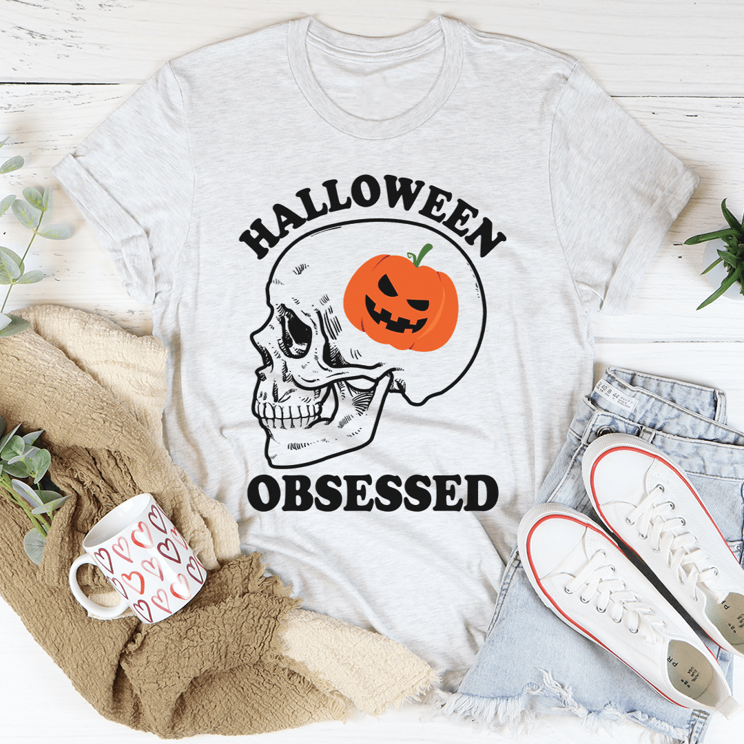 A black Halloween Obsessed T-Shirt featuring spooky graphics, made from soft ring-spun cotton with double stitching for durability.