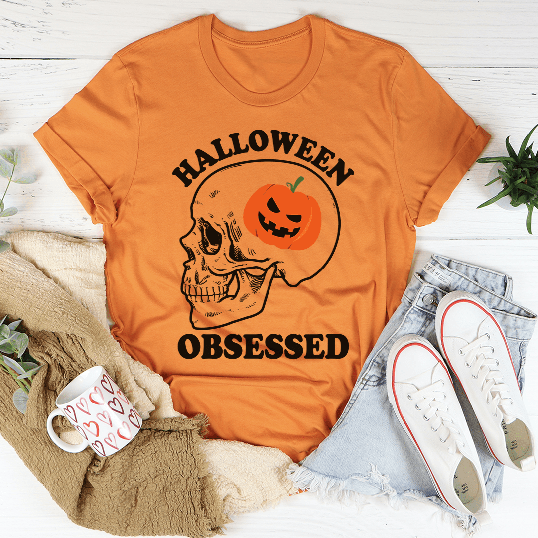 A black Halloween Obsessed T-Shirt featuring spooky graphics, made from soft ring-spun cotton with double stitching for durability.