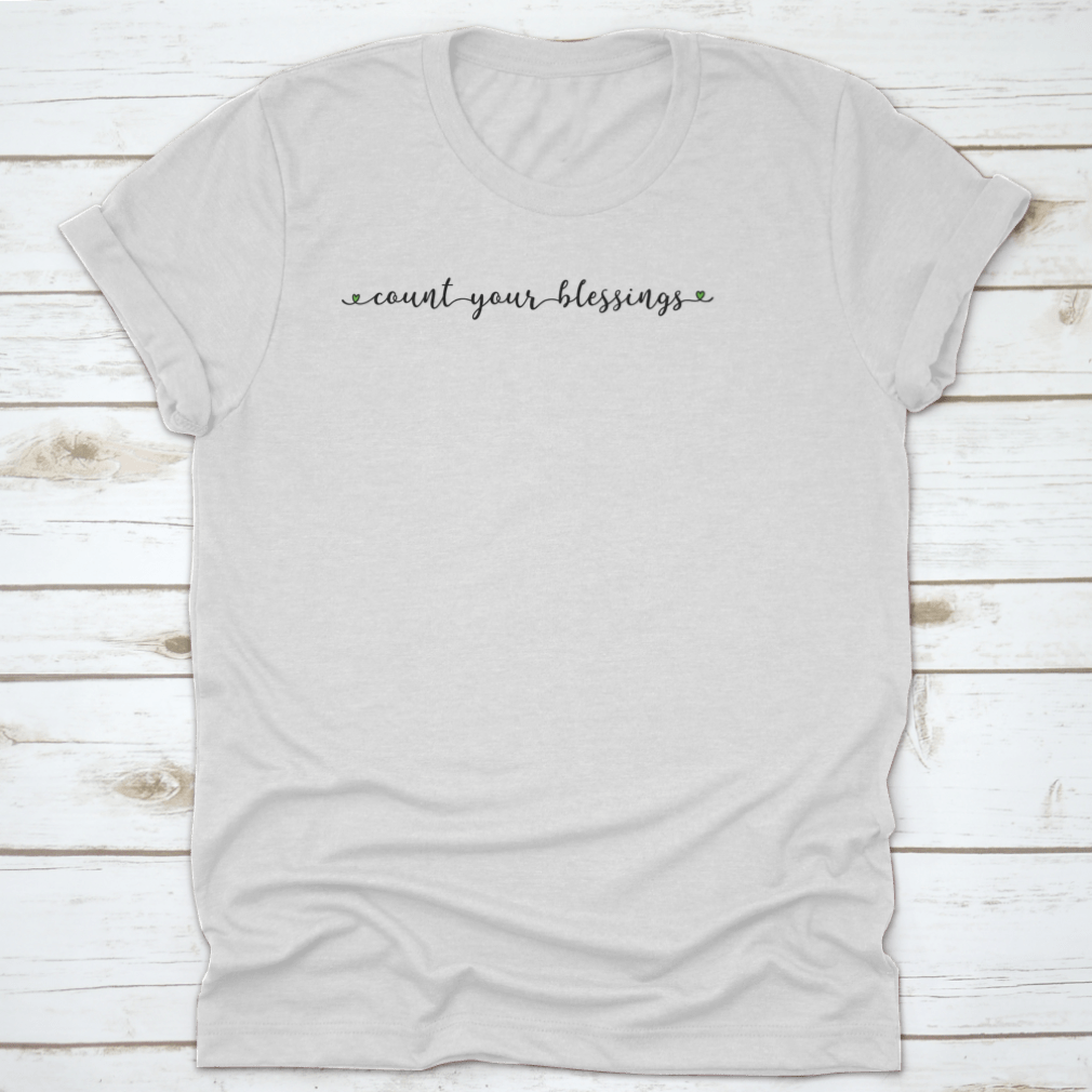 A stylish Hand Sketched Count Your Blessings T-Shirt featuring a unique design, made from 100% cotton for comfort.