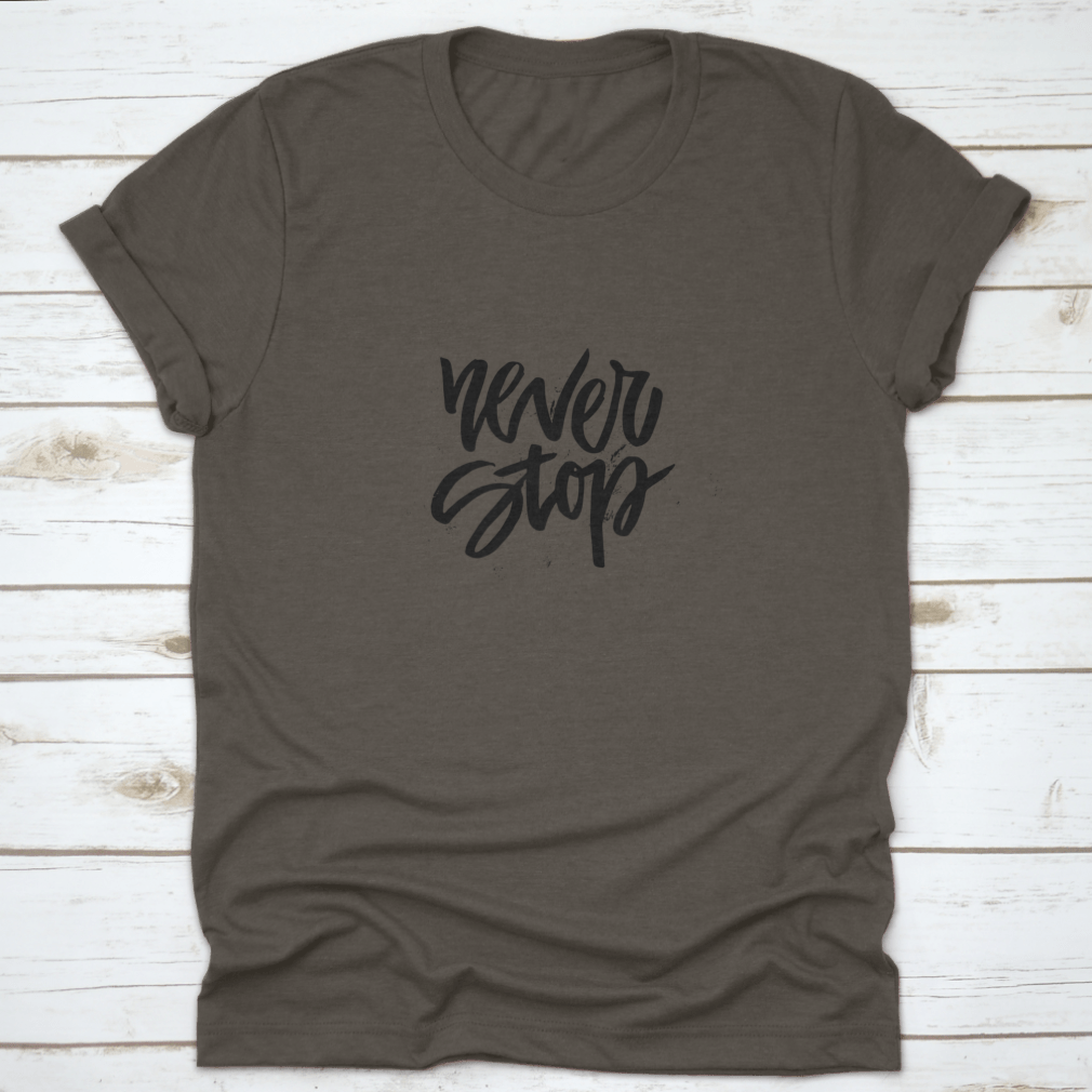 A stylish Handdrawn Lettering T-shirt featuring the motivational phrase 'Never Stop Inspiring' in a unique design.