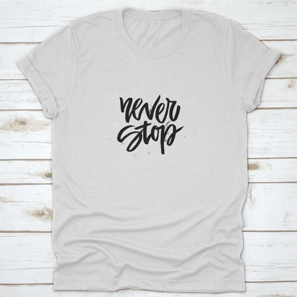 A stylish Handdrawn Lettering T-shirt featuring the motivational phrase 'Never Stop Inspiring' in a unique design.