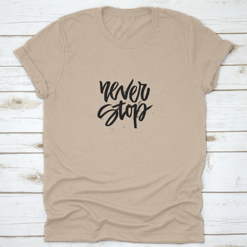 A stylish Handdrawn Lettering T-shirt featuring the motivational phrase 'Never Stop Inspiring' in a unique design.