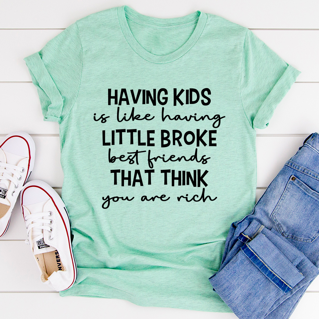 A humorous t-shirt featuring the phrase 'Having Kids Is Like Having Little Broke Friends', made from soft cotton with double stitching.