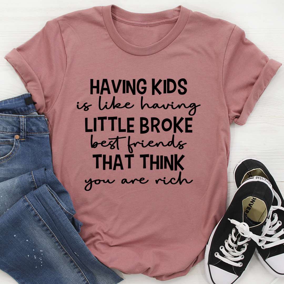 A humorous t-shirt featuring the phrase 'Having Kids Is Like Having Little Broke Friends', made from soft cotton with double stitching.