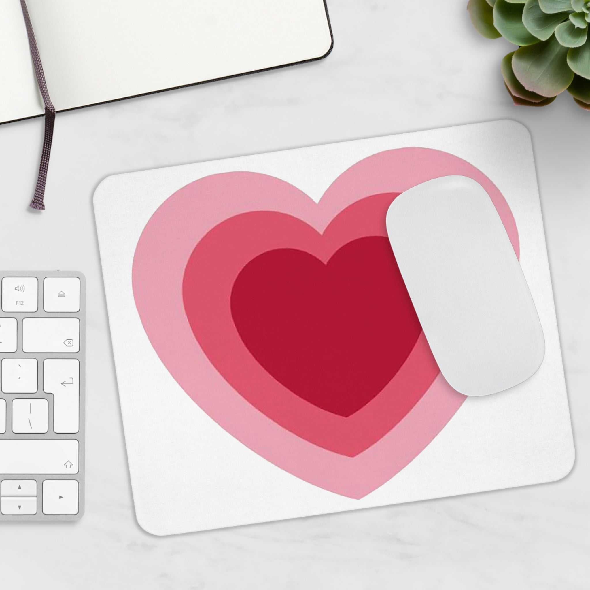 A stylish hearts design mouse pad with a non-slip rubber base, perfect for enhancing any workspace.