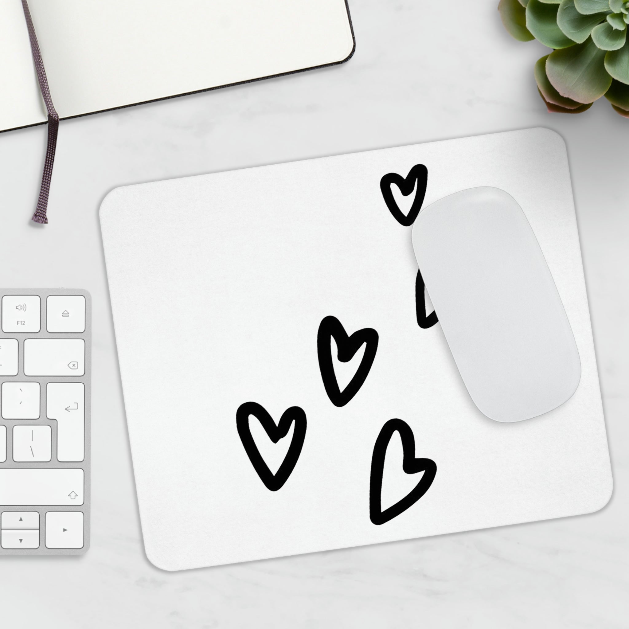 A stylish hearts-themed mouse pad designed for comfort and durability, featuring a non-slip base.