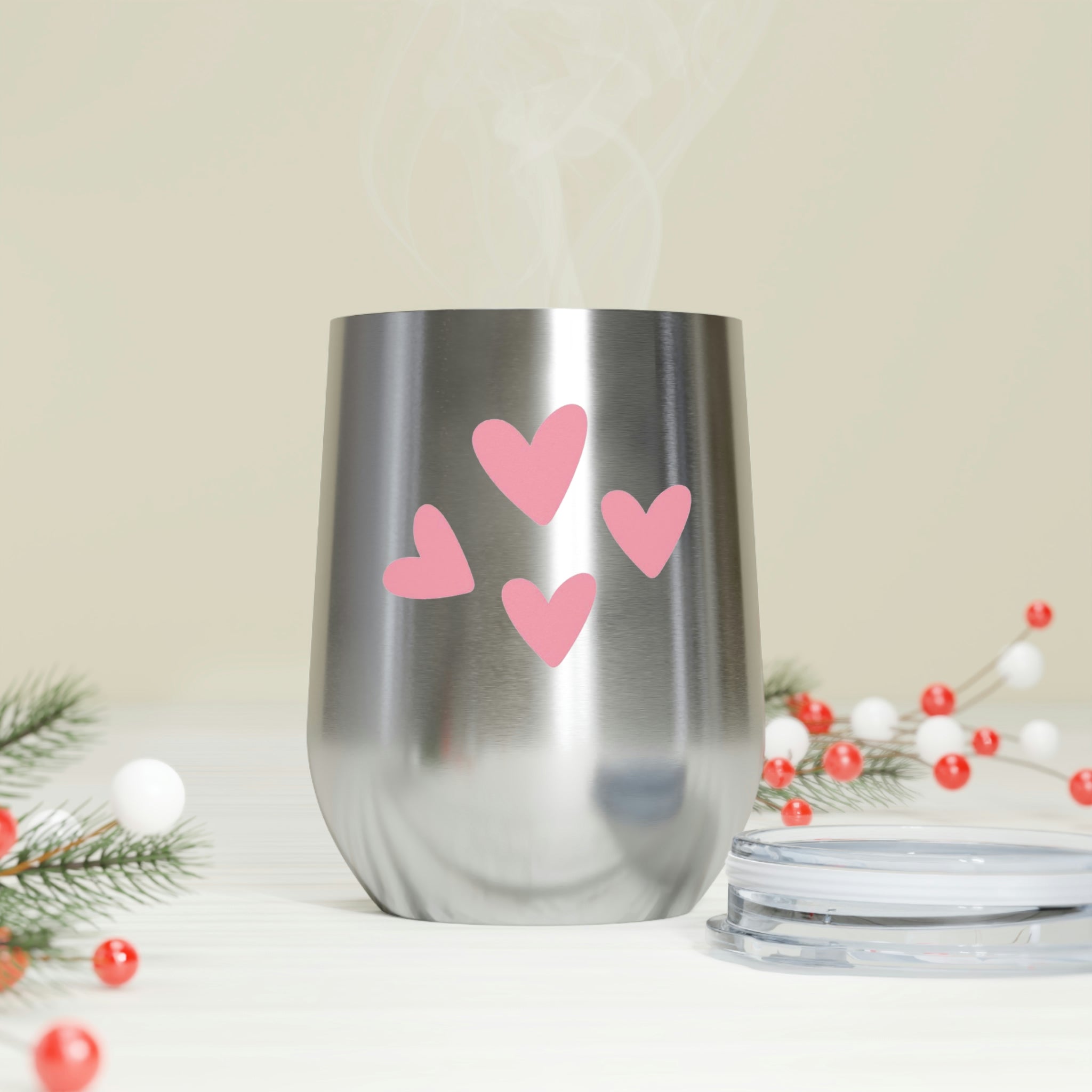 A stylish Hearts Wine Tumbler made of stainless steel with a clear plastic lid, perfect for hot and cold beverages.