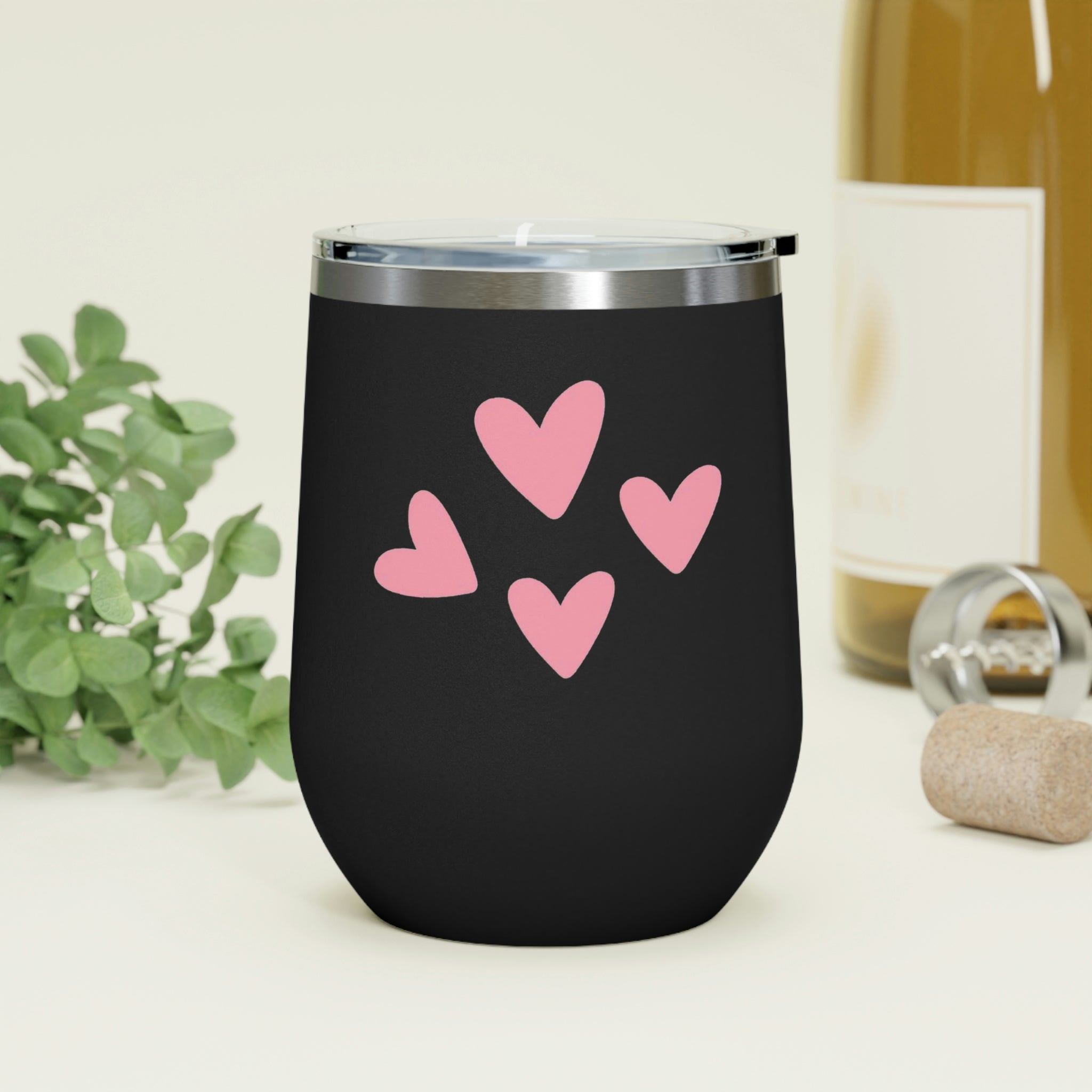 A stylish Hearts Wine Tumbler made of stainless steel with a clear plastic lid, perfect for hot and cold beverages.