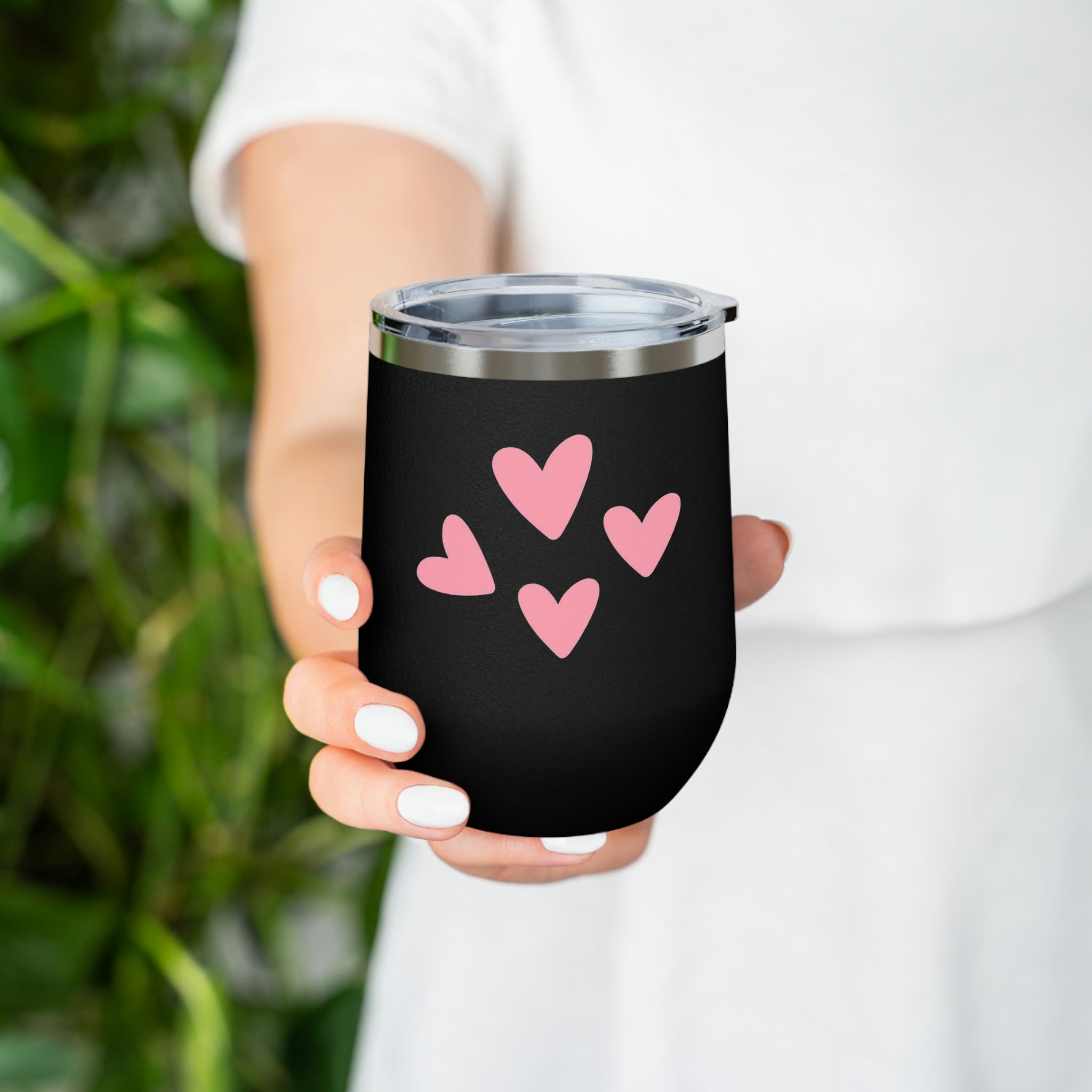 A stylish Hearts Wine Tumbler made of stainless steel with a clear plastic lid, perfect for hot and cold beverages.