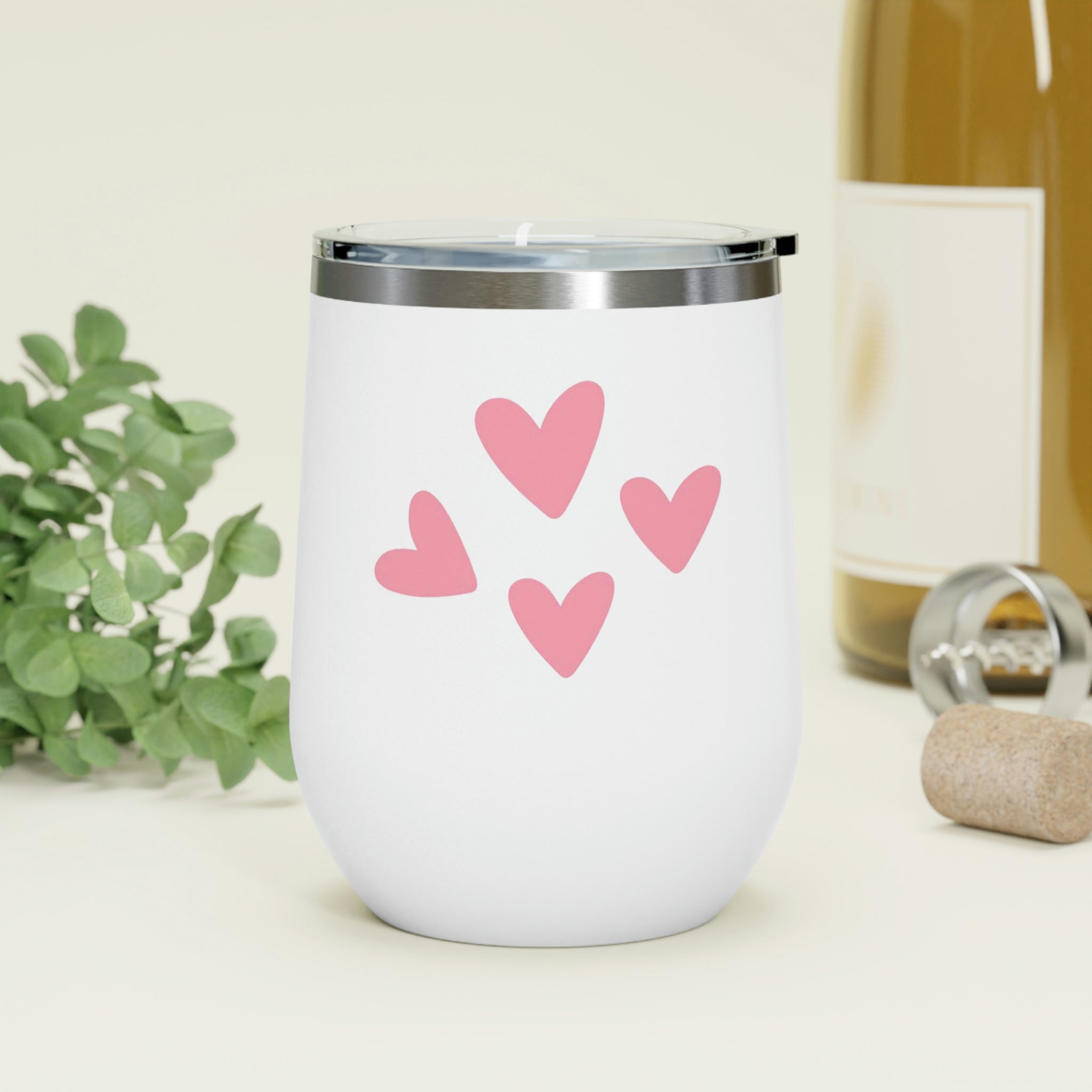 A stylish Hearts Wine Tumbler made of stainless steel with a clear plastic lid, perfect for hot and cold beverages.