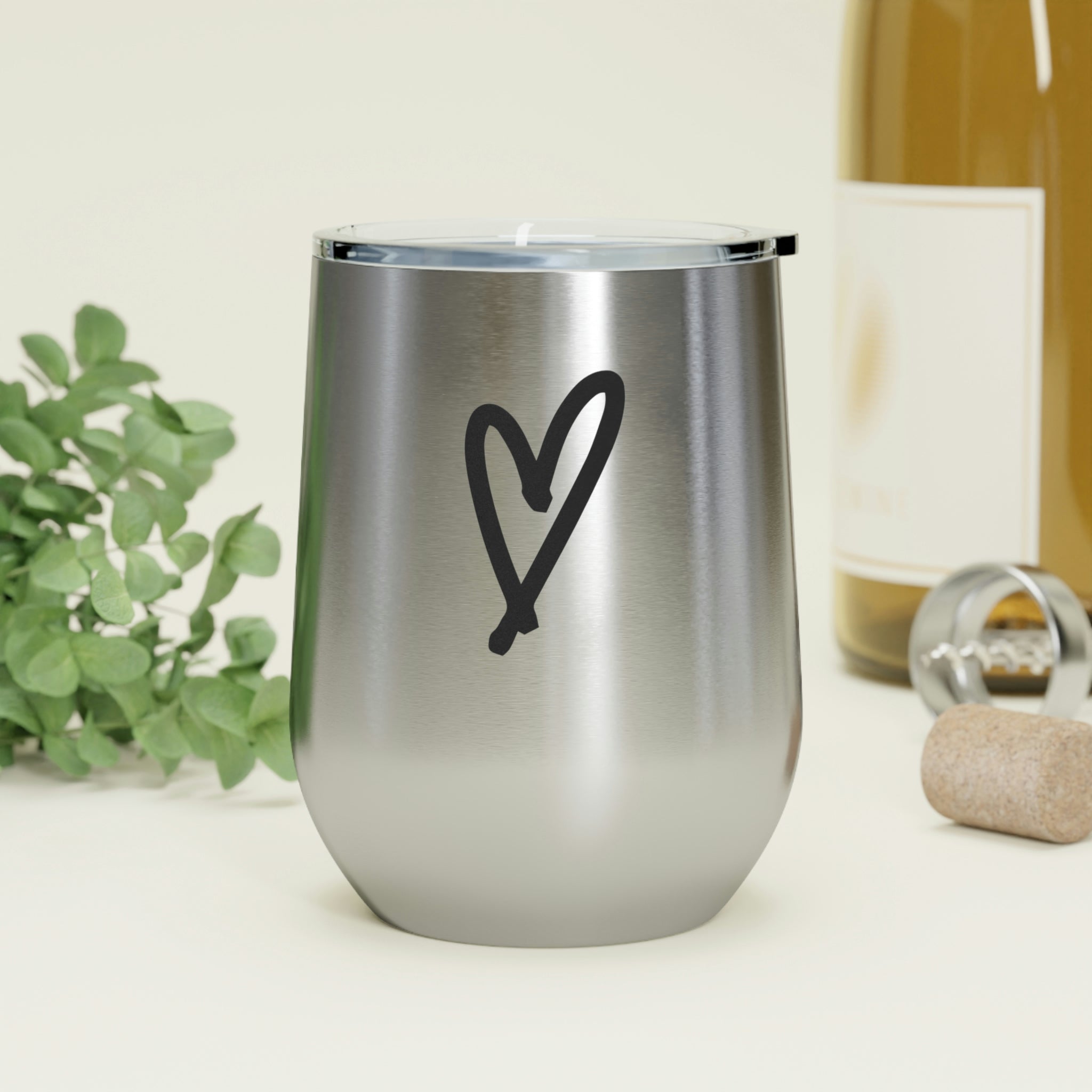 A stylish Hearts Wine Tumbler made of stainless steel with a clear plastic lid, perfect for hot and cold beverages.