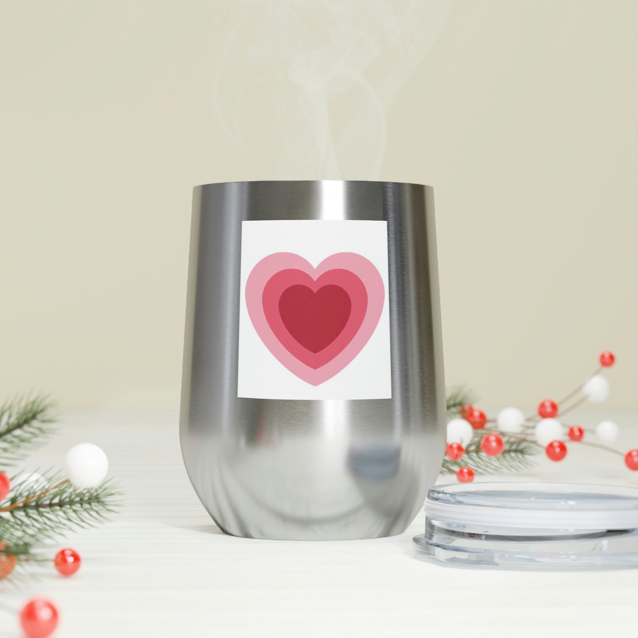 A stylish Hearts Wine Tumbler made of stainless steel with a clear plastic lid, perfect for hot and cold beverages.