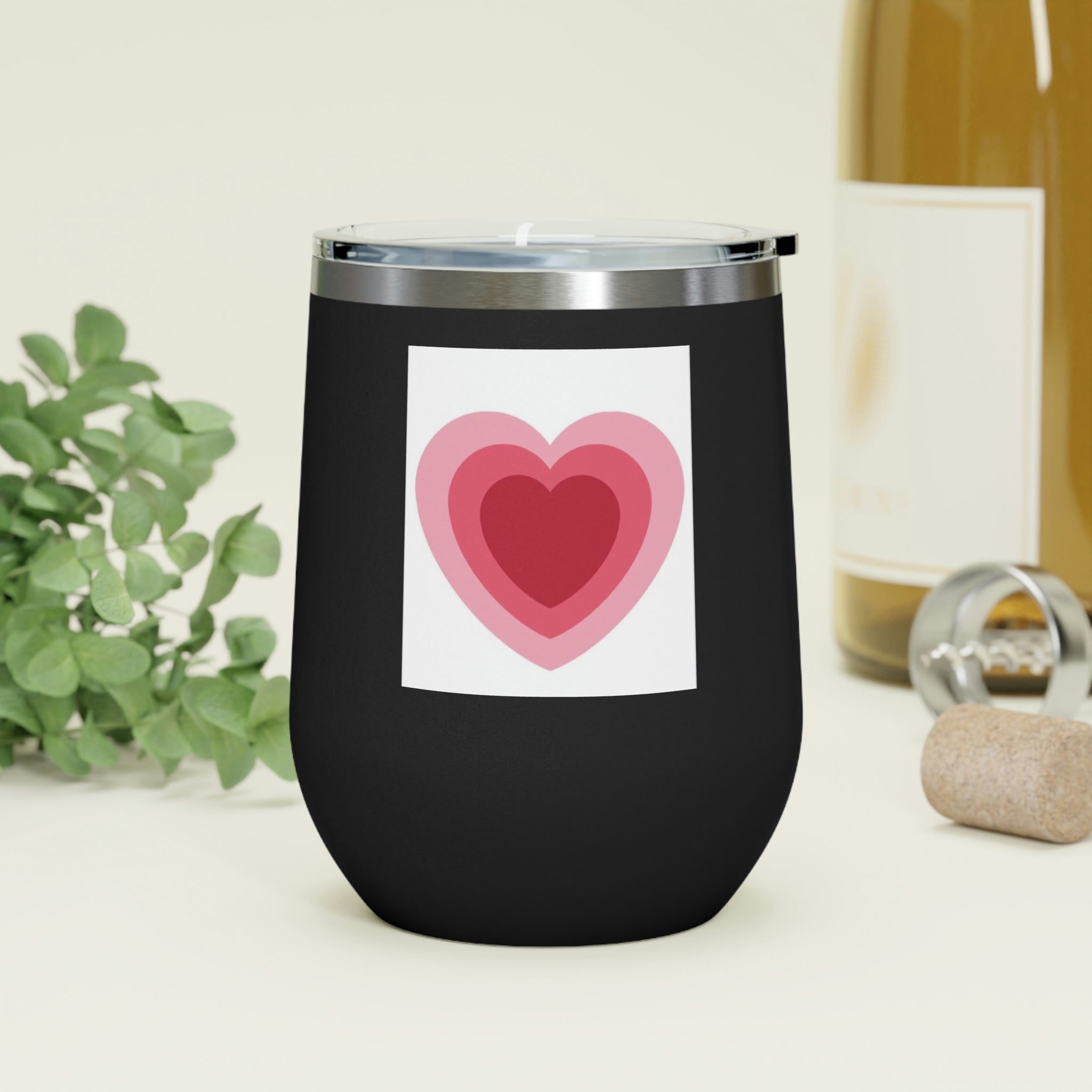 A stylish Hearts Wine Tumbler made of stainless steel with a clear plastic lid, perfect for hot and cold beverages.