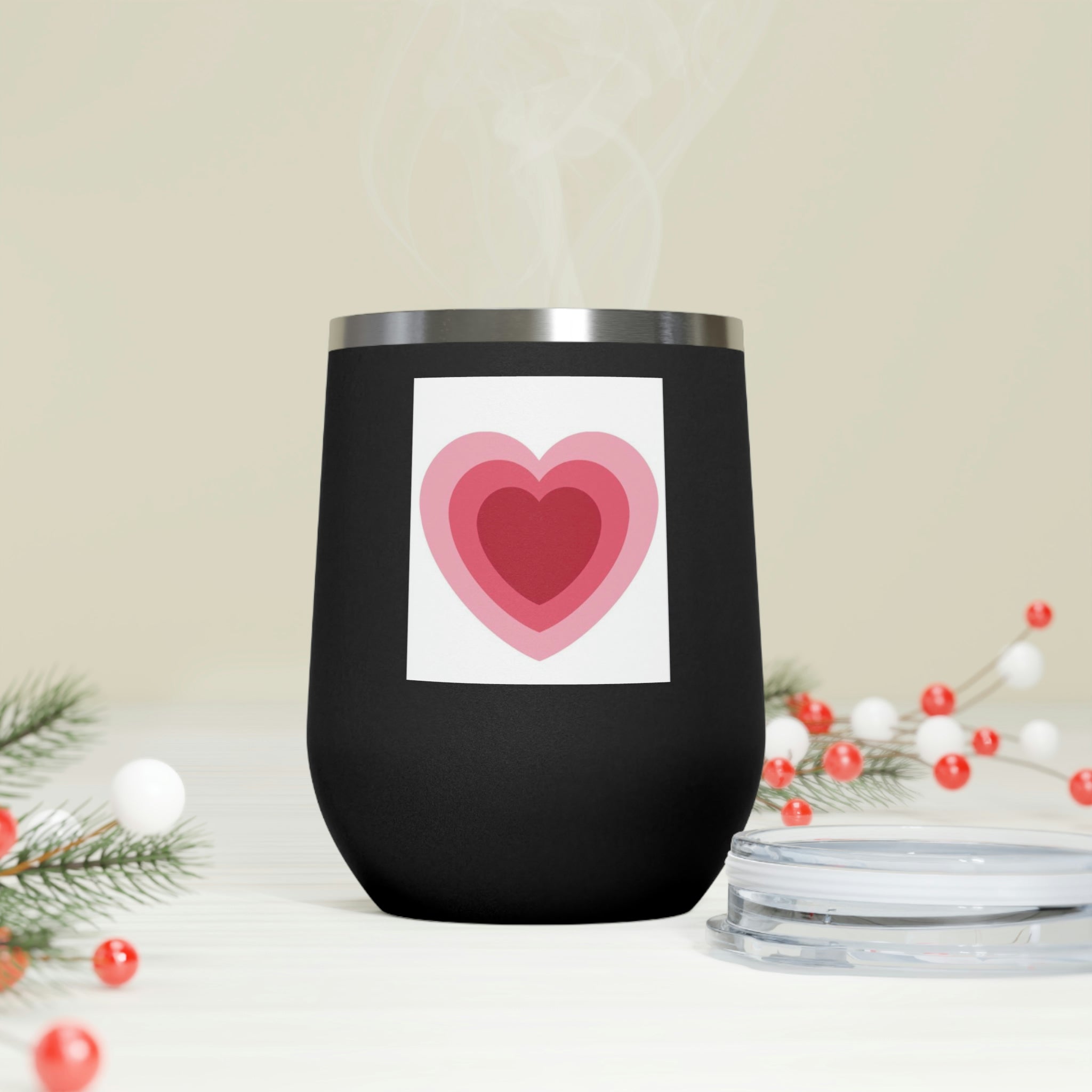 A stylish Hearts Wine Tumbler made of stainless steel with a clear plastic lid, perfect for hot and cold beverages.