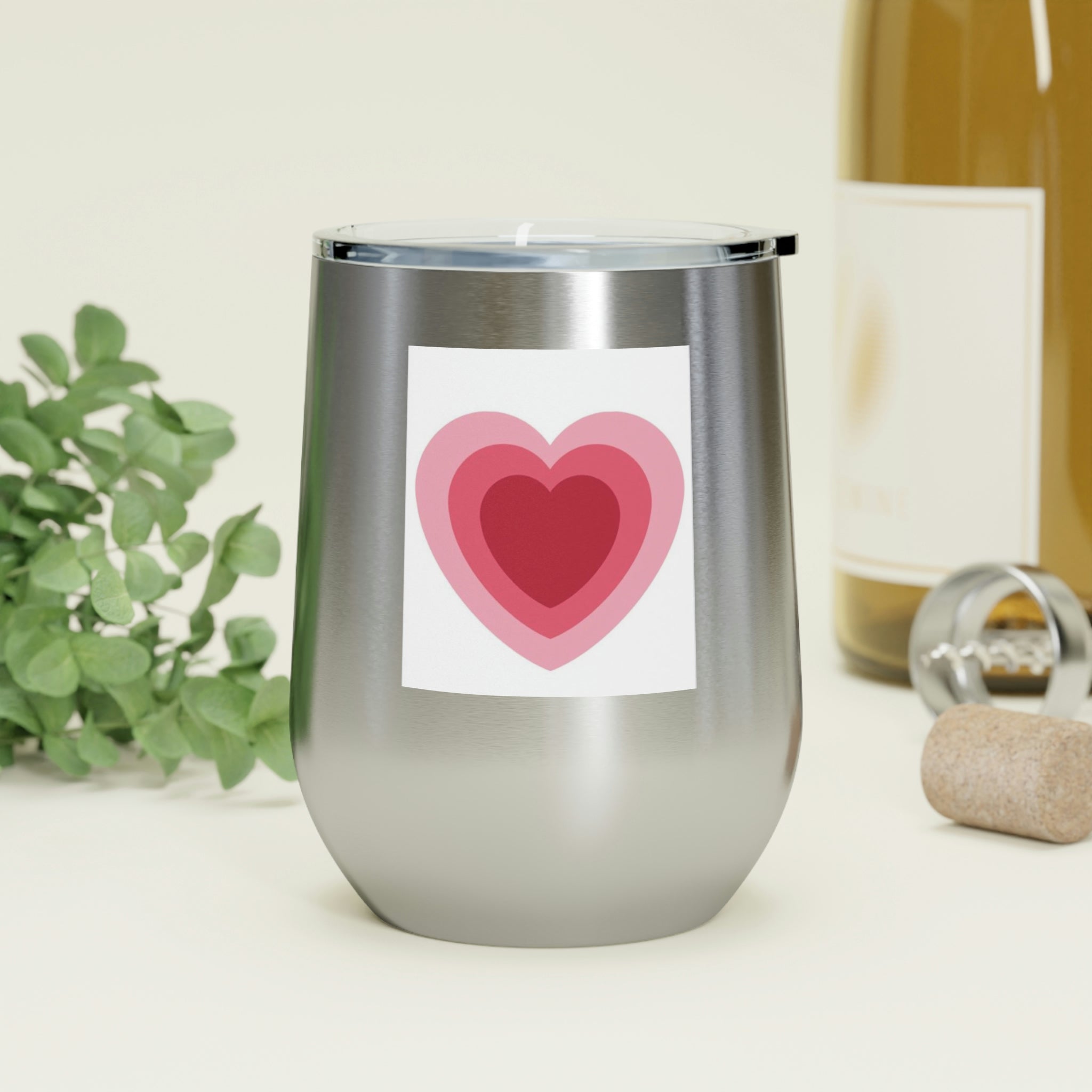 A stylish Hearts Wine Tumbler made of stainless steel with a clear plastic lid, perfect for hot and cold beverages.