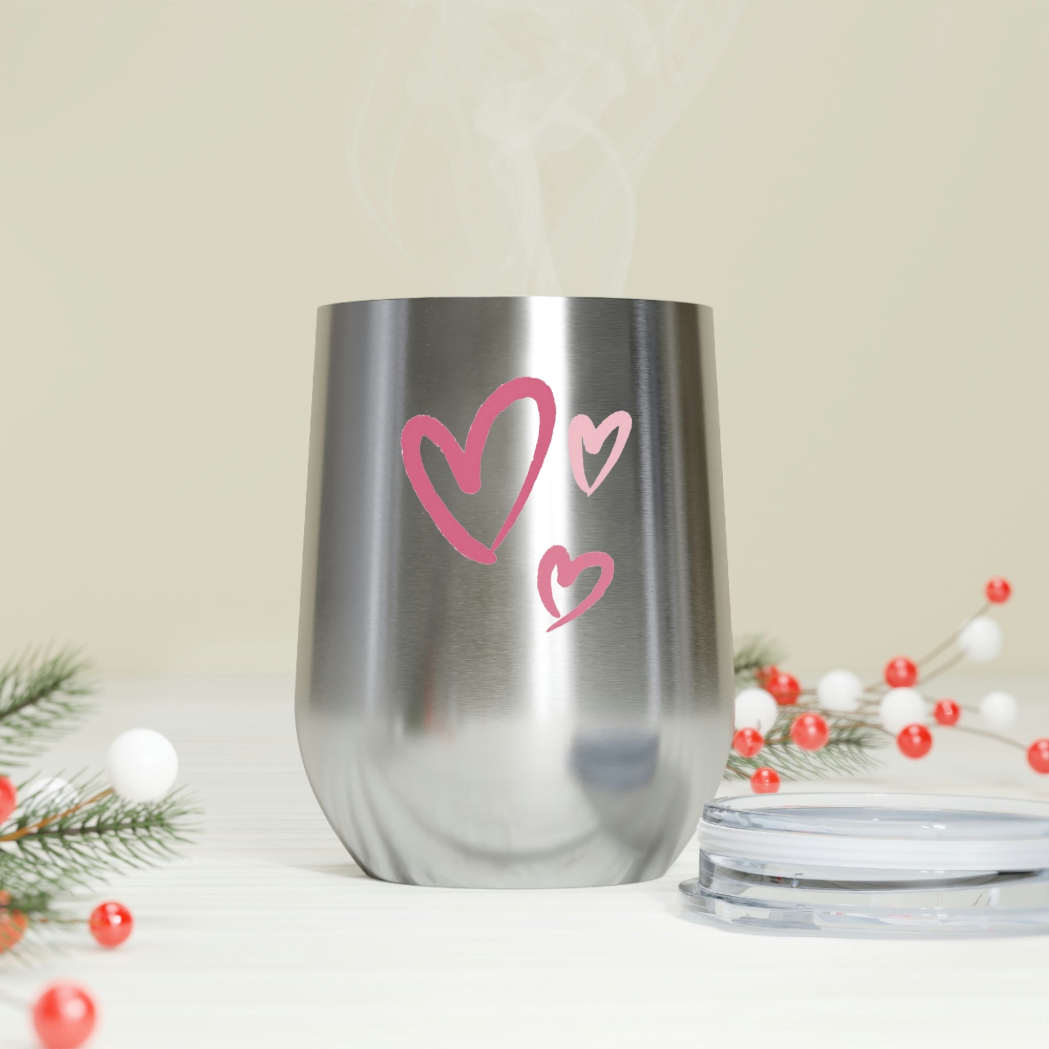 A stylish Hearts Wine Tumbler made of stainless steel with a clear plastic lid, showcasing a heart design, perfect for hot and cold beverages.