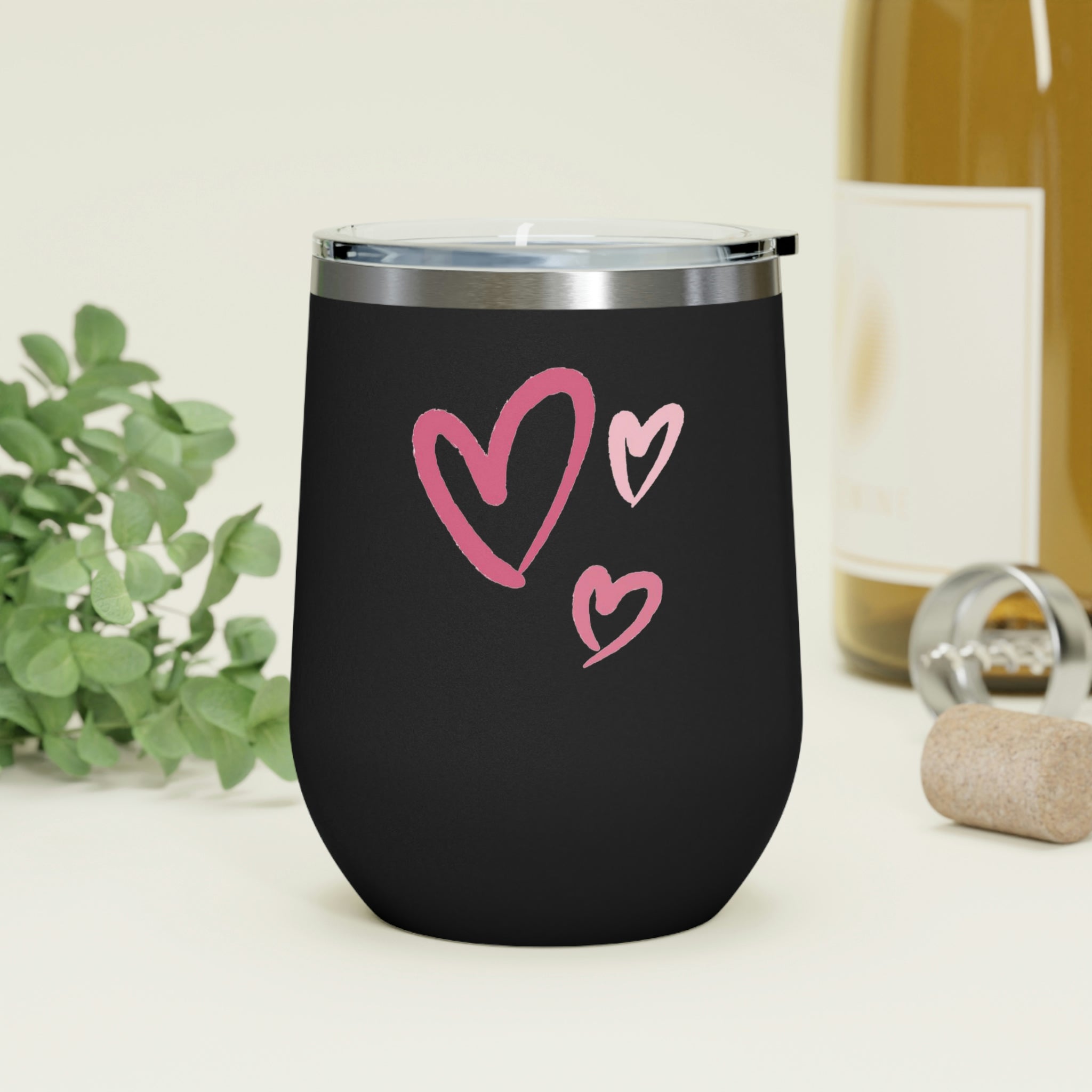 A stylish Hearts Wine Tumbler made of stainless steel with a clear plastic lid, showcasing a heart design, perfect for hot and cold beverages.