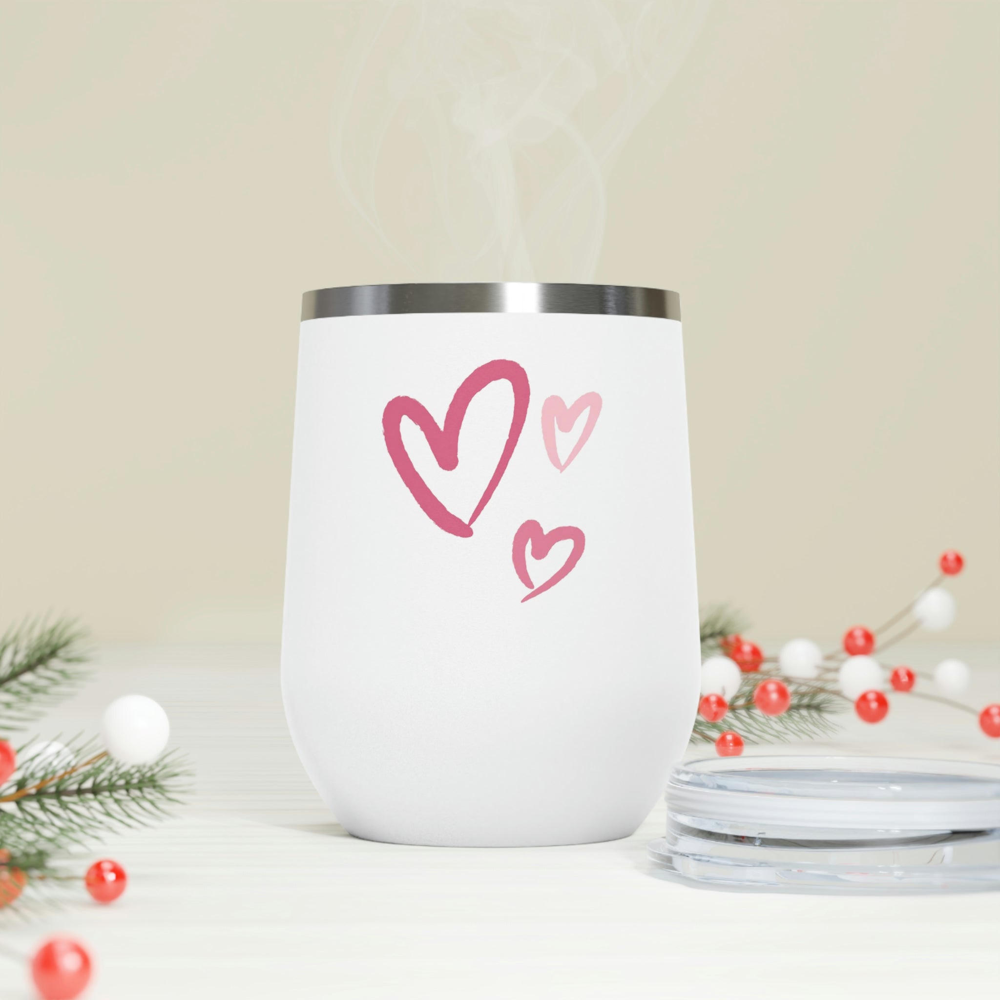 A stylish Hearts Wine Tumbler made of stainless steel with a clear plastic lid, showcasing a heart design, perfect for hot and cold beverages.