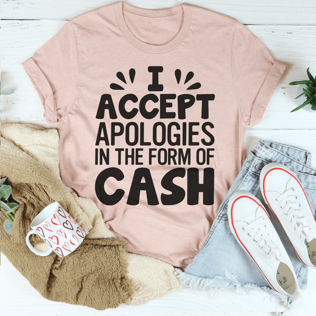 A humorous t-shirt featuring the phrase 'I Accept Apologies In The Form Of Cash', made from soft cotton with double stitching.