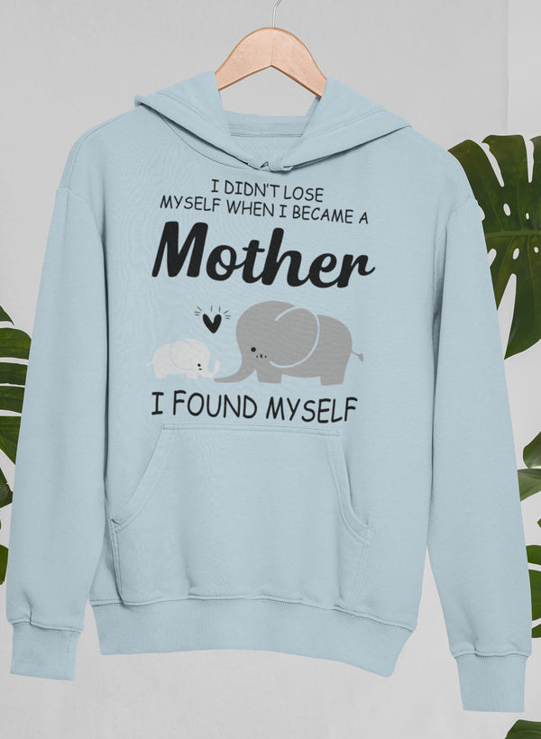 A cozy hoodie featuring the phrase 'I Didn't Lose Myself When I Became A Mother I Found Myself', showcasing a stylish design perfect for mothers.