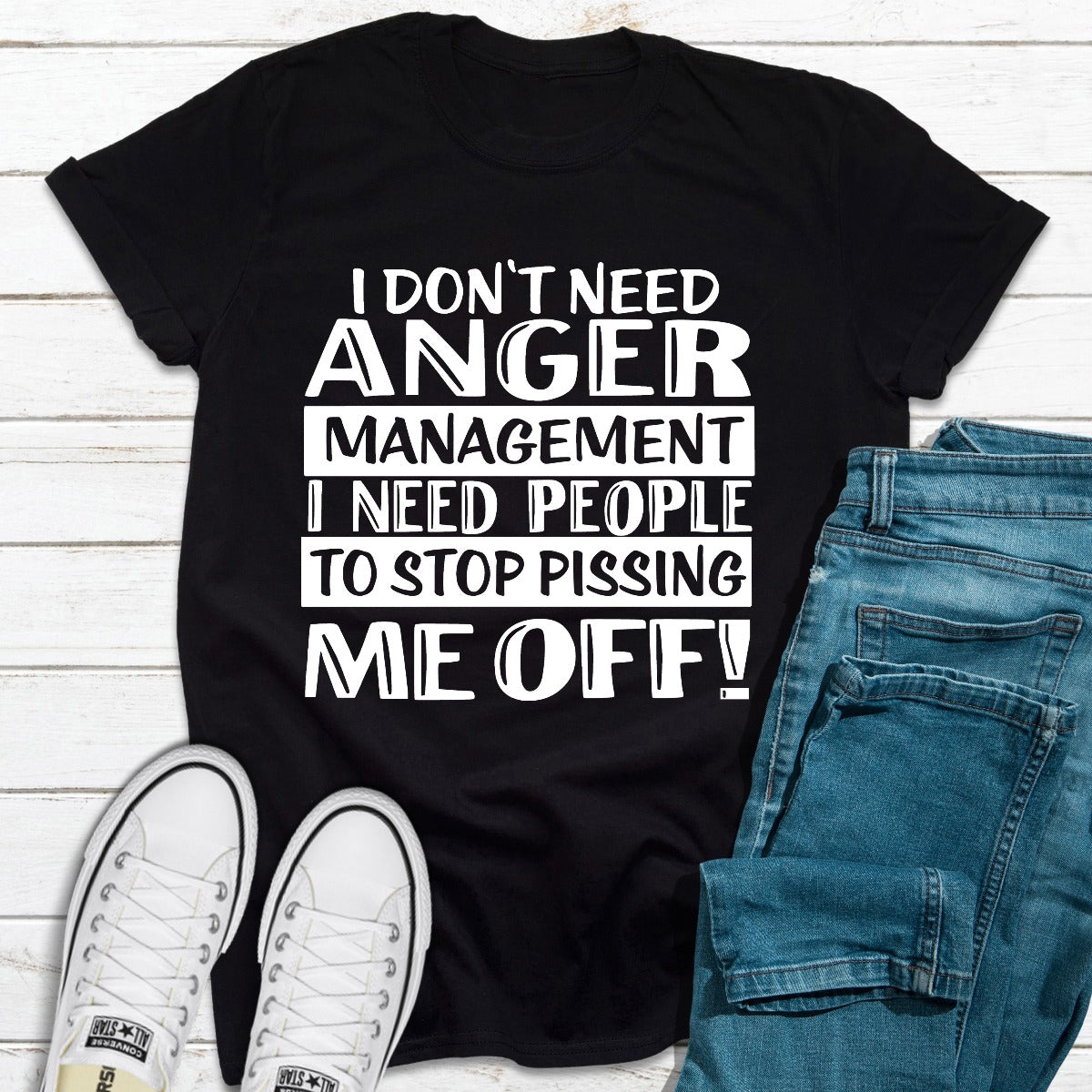 A black t-shirt with the phrase 'I Don't Need Anger Management' printed in bold white letters, showcasing a casual and humorous style.