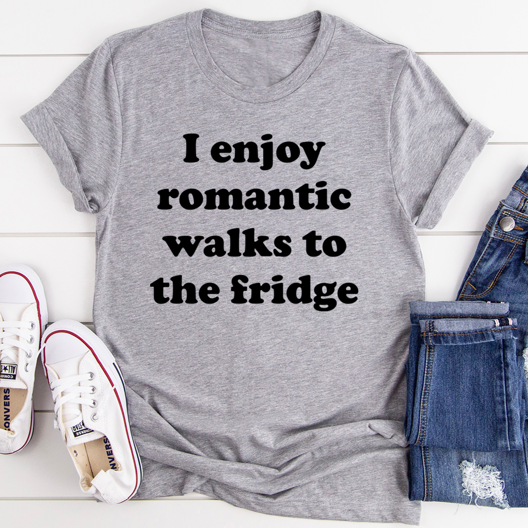 A humorous t-shirt with the phrase 'I Enjoy Romantic Walks To The Fridge' printed on it, showcasing its soft cotton fabric and durable stitching.