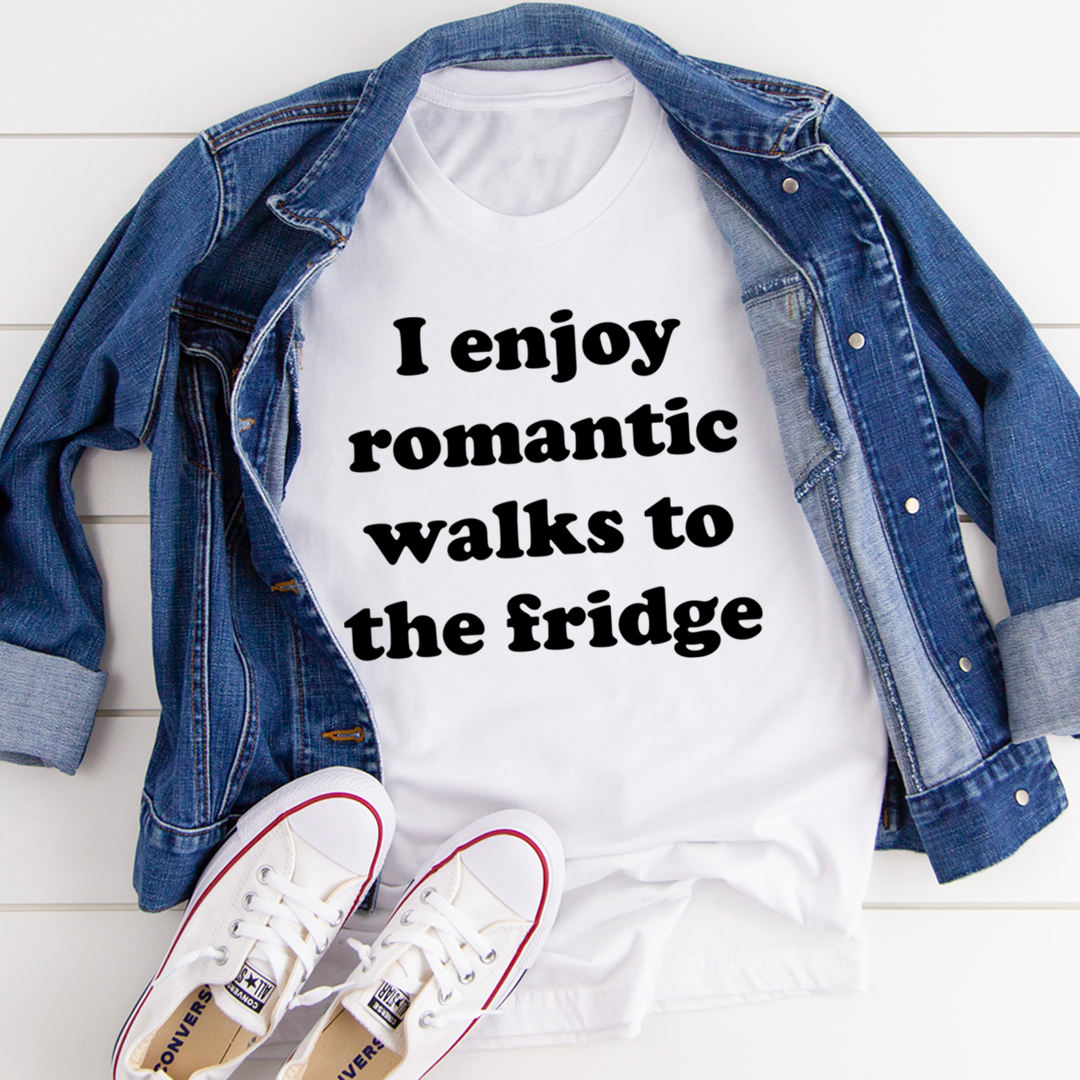 A humorous t-shirt with the phrase 'I Enjoy Romantic Walks To The Fridge' printed on it, showcasing its soft cotton fabric and durable stitching.