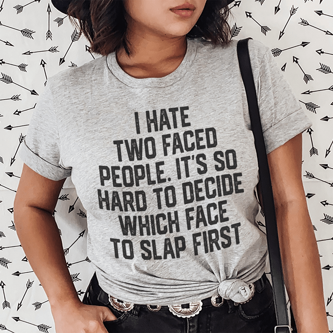 A humorous t-shirt featuring the phrase 'I Hate Two Faced People' printed on a soft, durable cotton fabric, showcasing its double stitching.