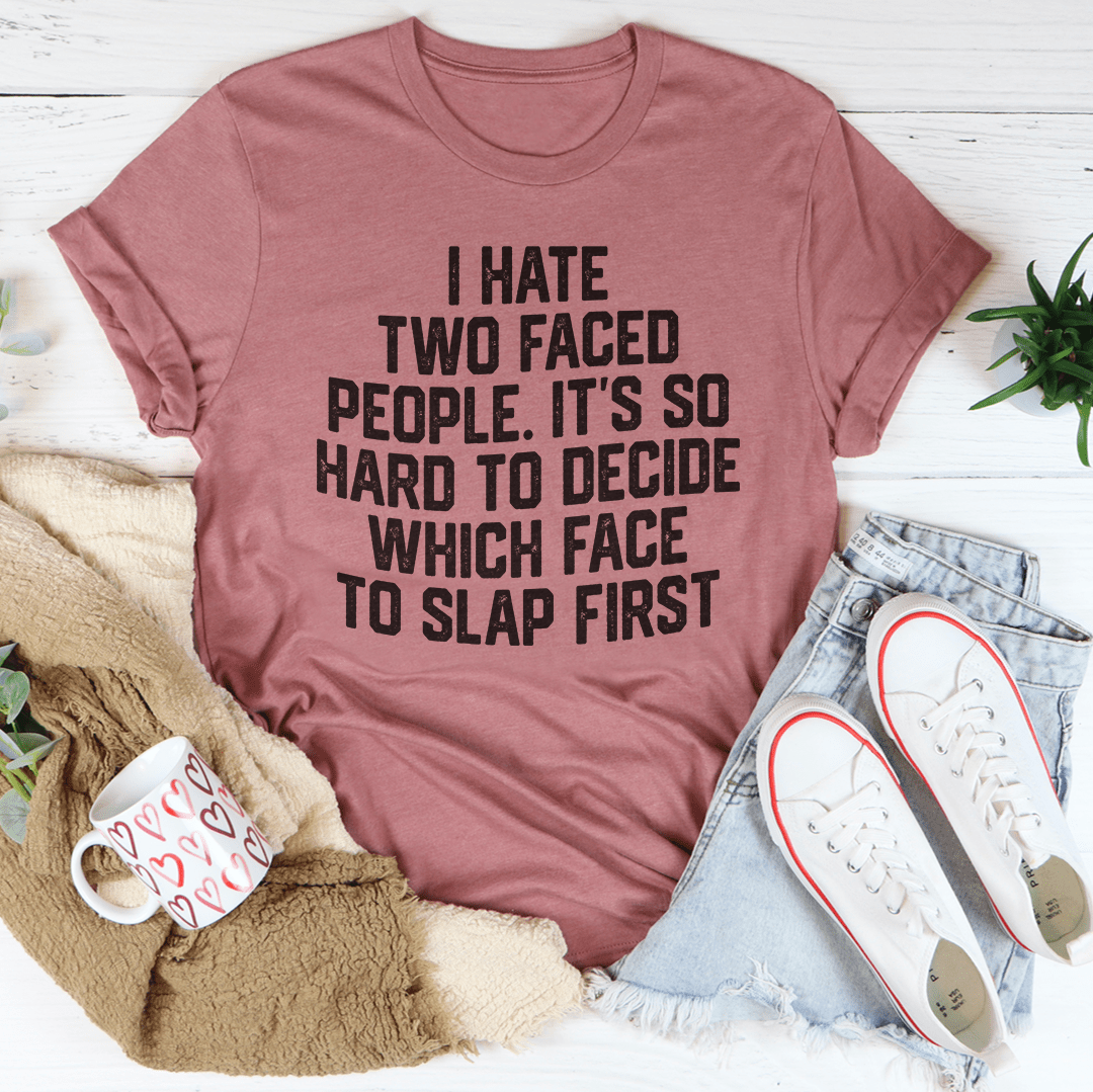 A humorous t-shirt featuring the phrase 'I Hate Two Faced People' printed on a soft, durable cotton fabric, showcasing its double stitching.