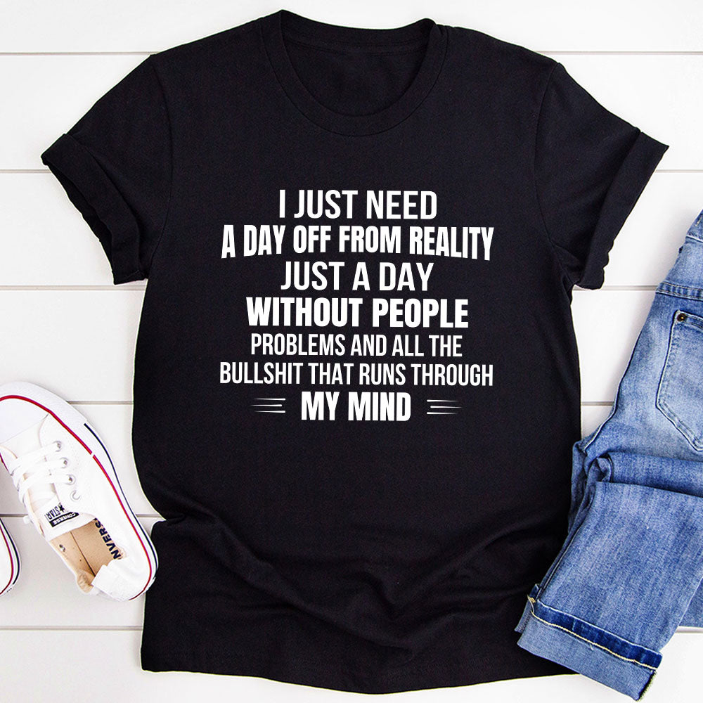 A comfortable and stylish t-shirt featuring the phrase 'I Just Need A Day Off From Reality', made from soft ring-spun cotton.