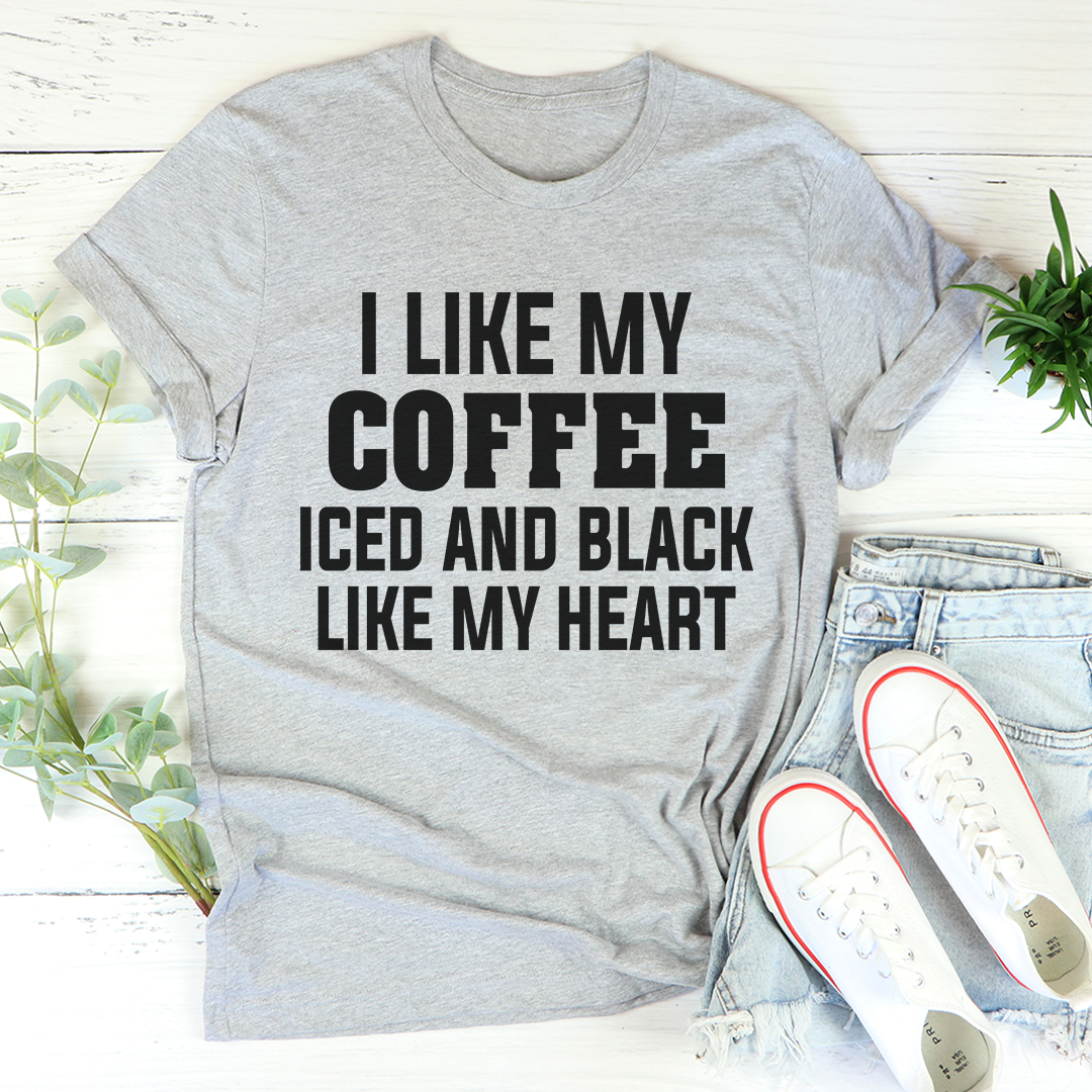 Black t-shirt with the phrase 'I Like My Coffee Iced And Black Like My Heart' printed in white, showcasing a stylish design for coffee lovers.