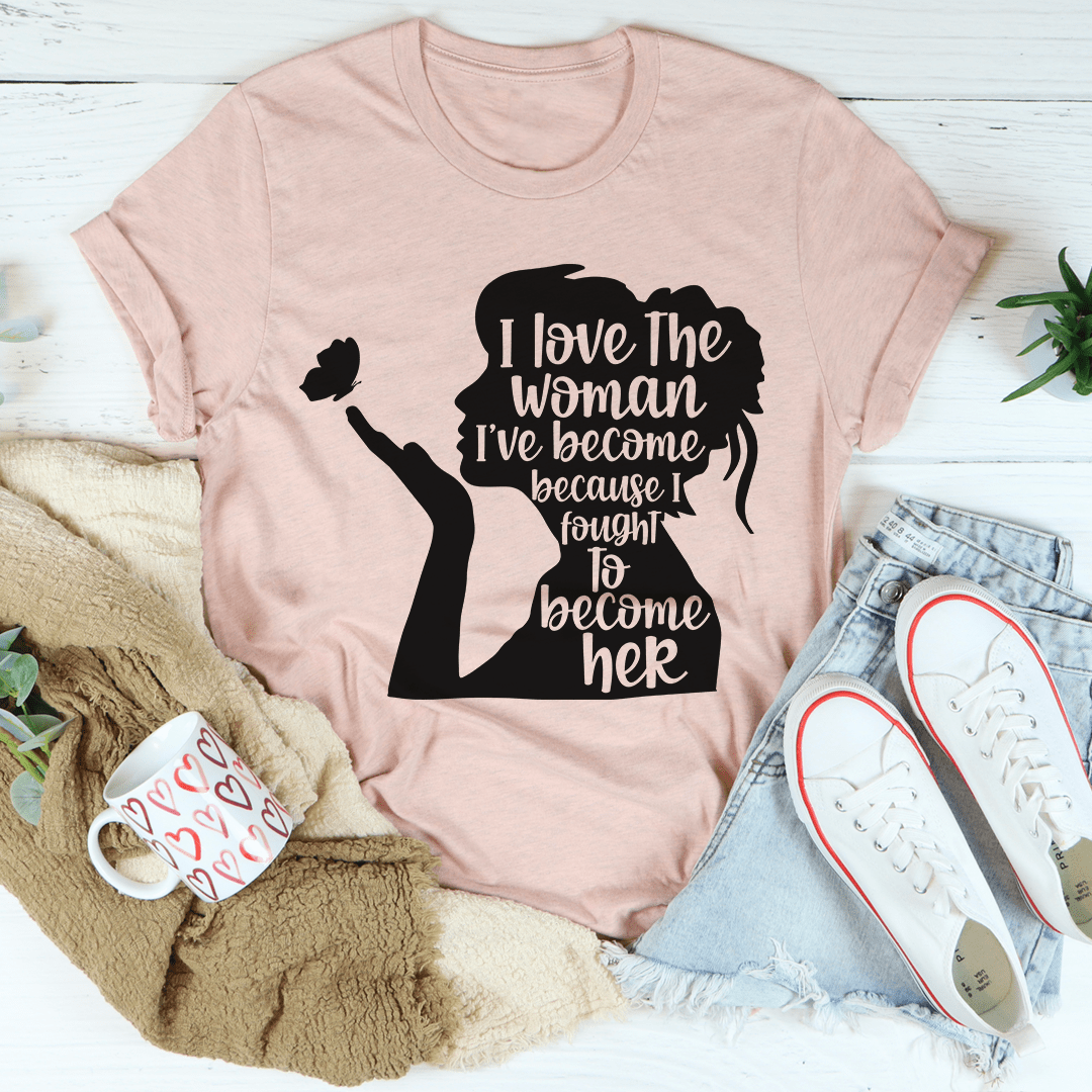 A stylish black t-shirt featuring the phrase 'I Love The Woman I've Become' in elegant typography, showcasing its soft fabric and durable stitching.