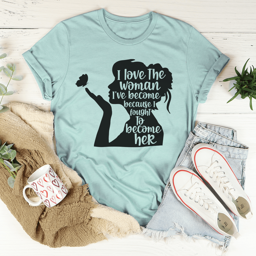 A stylish black t-shirt featuring the phrase 'I Love The Woman I've Become' in elegant typography, showcasing its soft fabric and durable stitching.