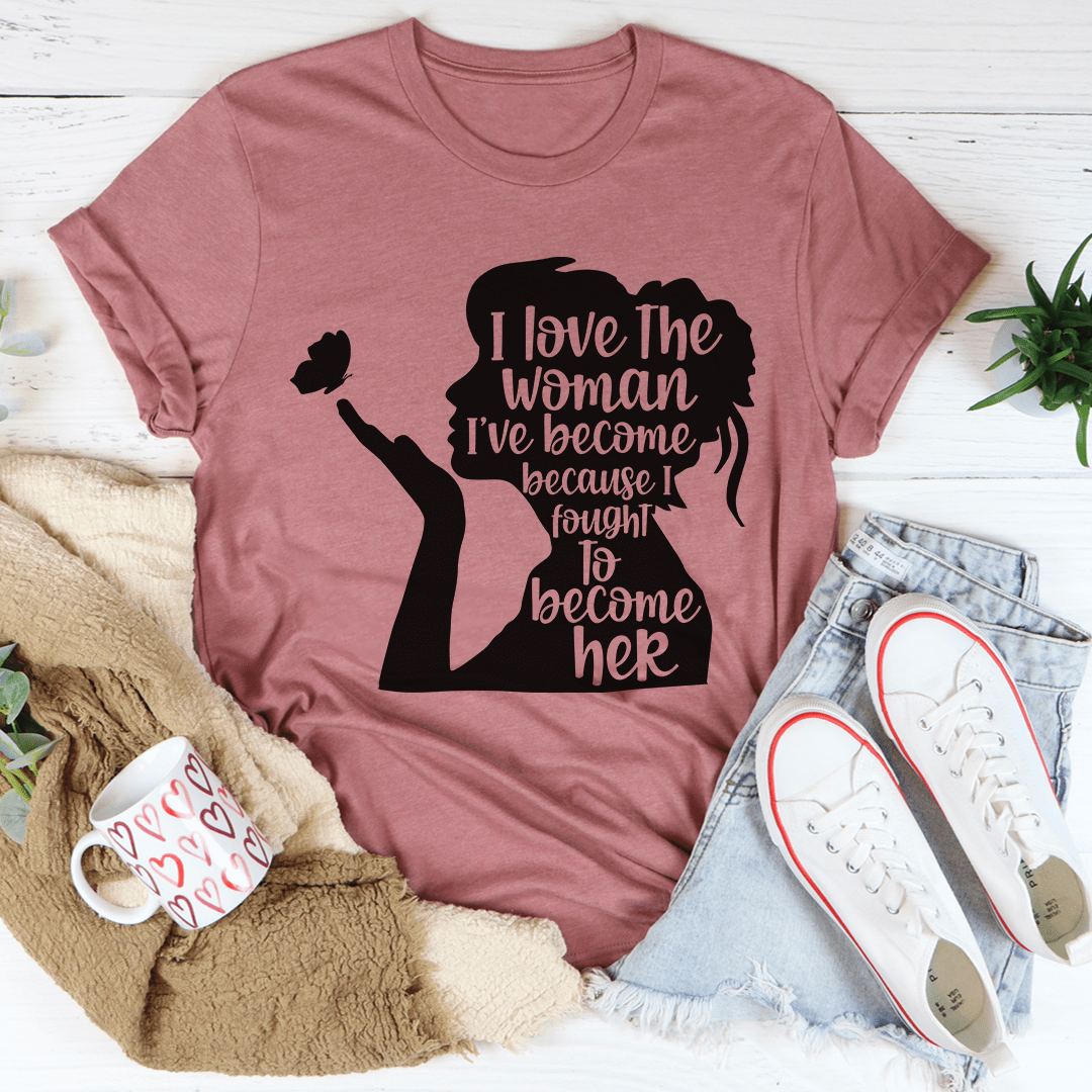 A stylish black t-shirt featuring the phrase 'I Love The Woman I've Become' in elegant typography, showcasing its soft fabric and durable stitching.