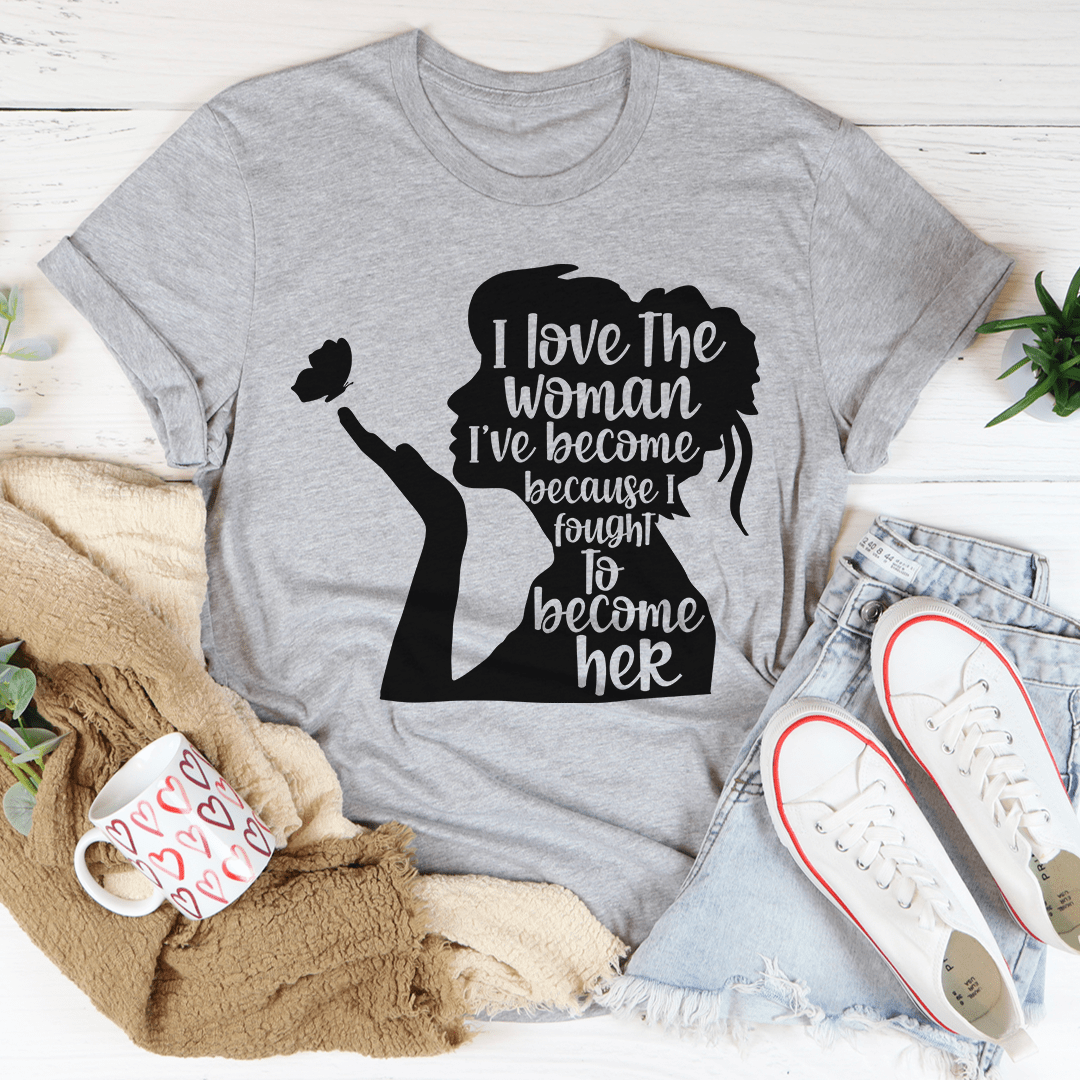 A stylish black t-shirt featuring the phrase 'I Love The Woman I've Become' in elegant typography, showcasing its soft fabric and durable stitching.