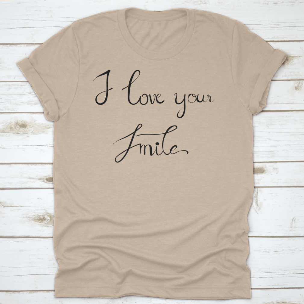 A stylish t-shirt featuring the handwritten calligraphy 'I Love Your Smile' on a white background, showcasing its unique design.