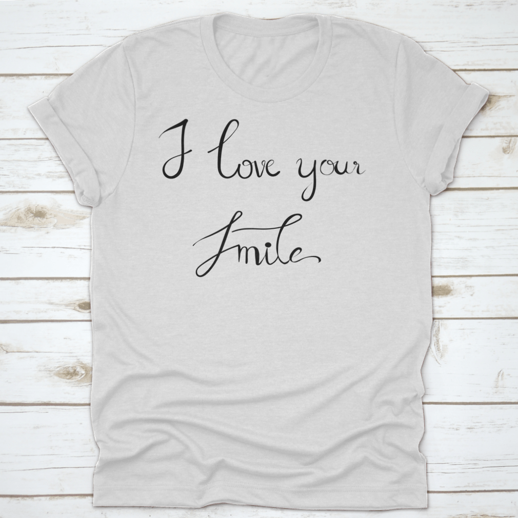 A stylish t-shirt featuring the handwritten calligraphy 'I Love Your Smile' on a white background, showcasing its unique design.