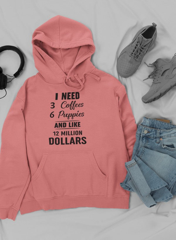 A cozy hoodie featuring the phrase 'I Need 3 Coffees 6 Puppies And Like 12 Million Dollars' designed for comfort and style.