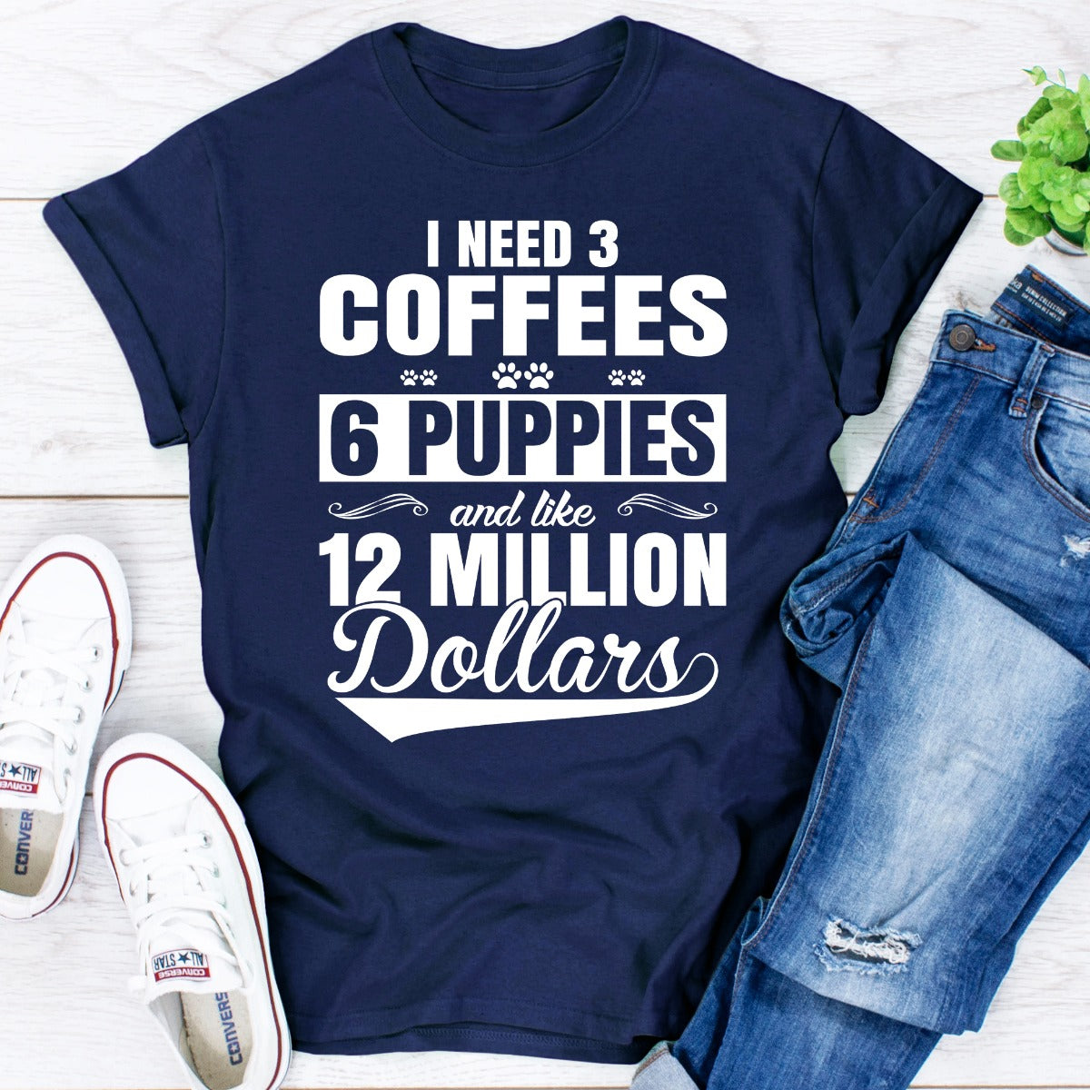 I Need 3 Coffees 6 Puppies And Like 12 Million Dollars T-Shirt displayed on a mannequin, showcasing its soft cotton fabric and unique design.