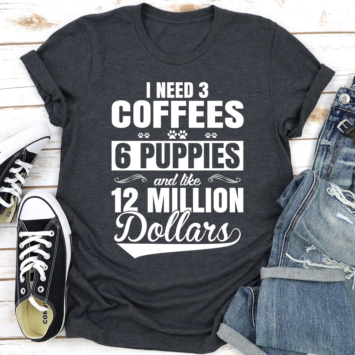 I Need 3 Coffees 6 Puppies And Like 12 Million Dollars T-Shirt displayed on a mannequin, showcasing its soft cotton fabric and unique design.